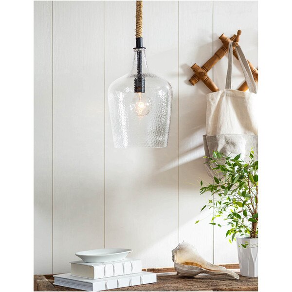 Wooden console table with white books and a glass pendant